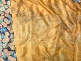 yellow and black silk sari with floral design on it