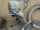 a small machine that is sitting next to a pile of hoses