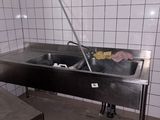 a sink in a kitchen with a towel on the counter