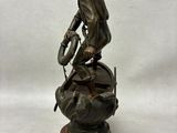 bronze statue of a man on a horse with a dog