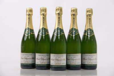 four bottles of champagne are lined up in a row