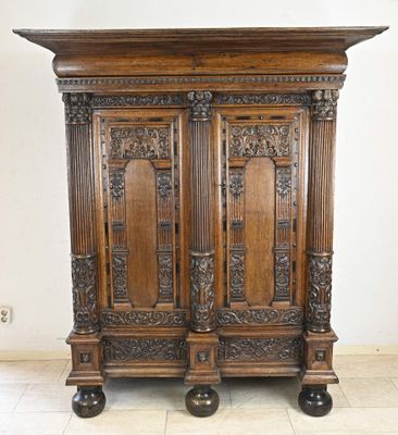 a large wooden cabinet with carvings on the top of it