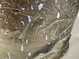 a close up of a vase with blue paint on it