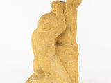 an image of a statue of a man and a woman sitting on a rock