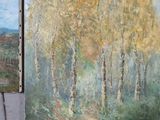 two paintings of trees on the wall next to each other