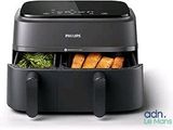 philips air fryer with vegetables and meat in it on a white background