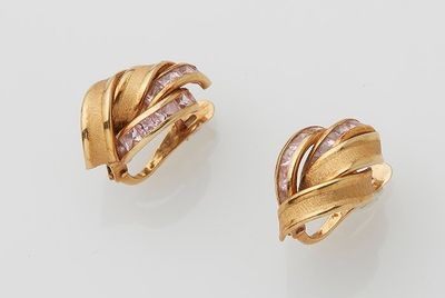 a pair of gold and diamond ear clips