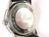 a close up of a watch on a white surface