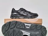 a pair of black and silver running shoes on top of a box