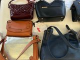 many different purses on a table in a store