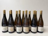 six bottles of wine lined up in a row on a table