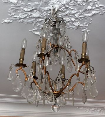 a crystal chandelier hanging from the ceiling in a room