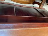 a wooden bench that has a wooden seat on top of it