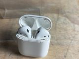 two airpods sitting in a clear case on a table