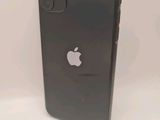a close up of a black iphone sitting on a white surface