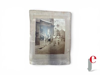 an old photo of a group of people walking down the street