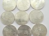 six different types of coins are shown on a white surface