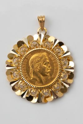 a close up of a gold coin on a white surface