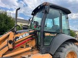 a backhoe of a tractor that is parked in a lot