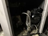 a dirty furnace with a hose in the middle of it