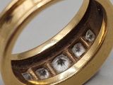 a close up of a gold ring with letters inside of it