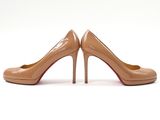 a pair of nude colored high heels on a white background