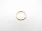 a close up of a gold ring on a white surface