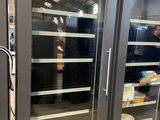 two refrigerators that have food inside of them in a store