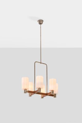a close up of a chandelier with four lamps on it