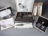 many silverware items in a case on a table