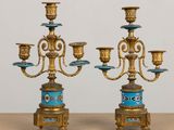 pair of antique brass candelabs with blue and gold decorations
