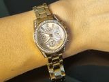 a woman that is wearing a watch on her wrist