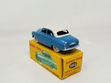 a blue toy car sitting on top of a yellow box