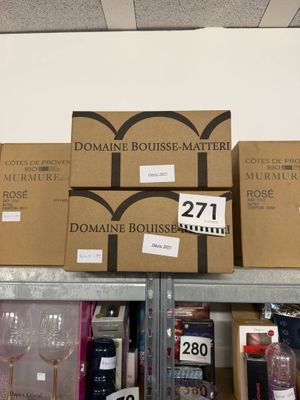 several boxes of wine are stacked on top of each other on a shelf