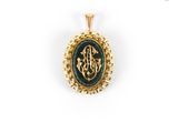 a gold pendant with a green stone and a gold chain