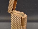 a gold lighter that is sitting on a table