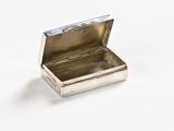 a small silver box that is open on a white surface