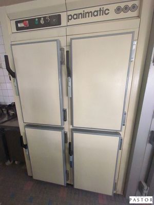 two refrigerators that are sitting in a kitchen