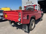 a red pick up truck parked in front of a building