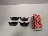 four pairs of glasses and a red box on a white surface