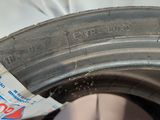 someone is holding a piece of paper that has been placed on a tire