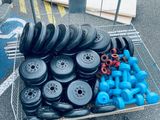 a cart full of wheels and blue dumbs on the street