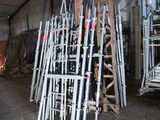 a pile of ladders stacked up in a warehouse