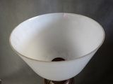 a white bowl sitting on top of a wooden stand
