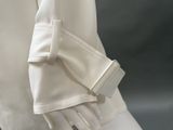 a close up of a mannequin wearing a white shirt and gloves