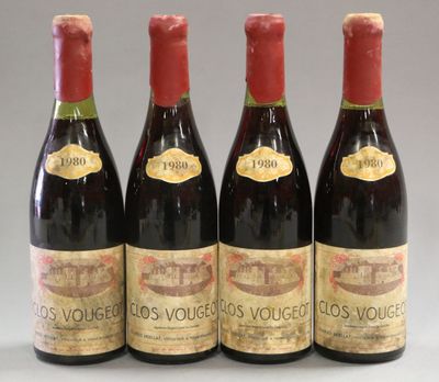 three bottles of red wine are lined up in a row