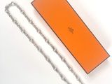 an orange box with a chain attached to it sitting on a white surface
