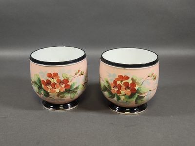 pair of hand painted porcelain egg cups with black rims