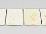 four pieces of white marble on a white surface