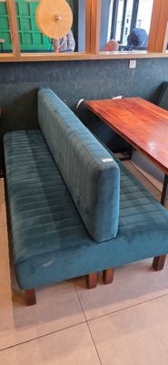 a bench and a table in the corner of a restaurant